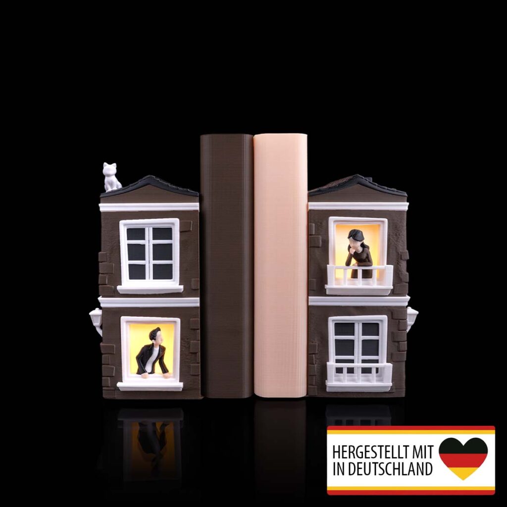 Buchstütze Sehnsucht mit beleuchteten Häuserfenstern im 3D-Druck